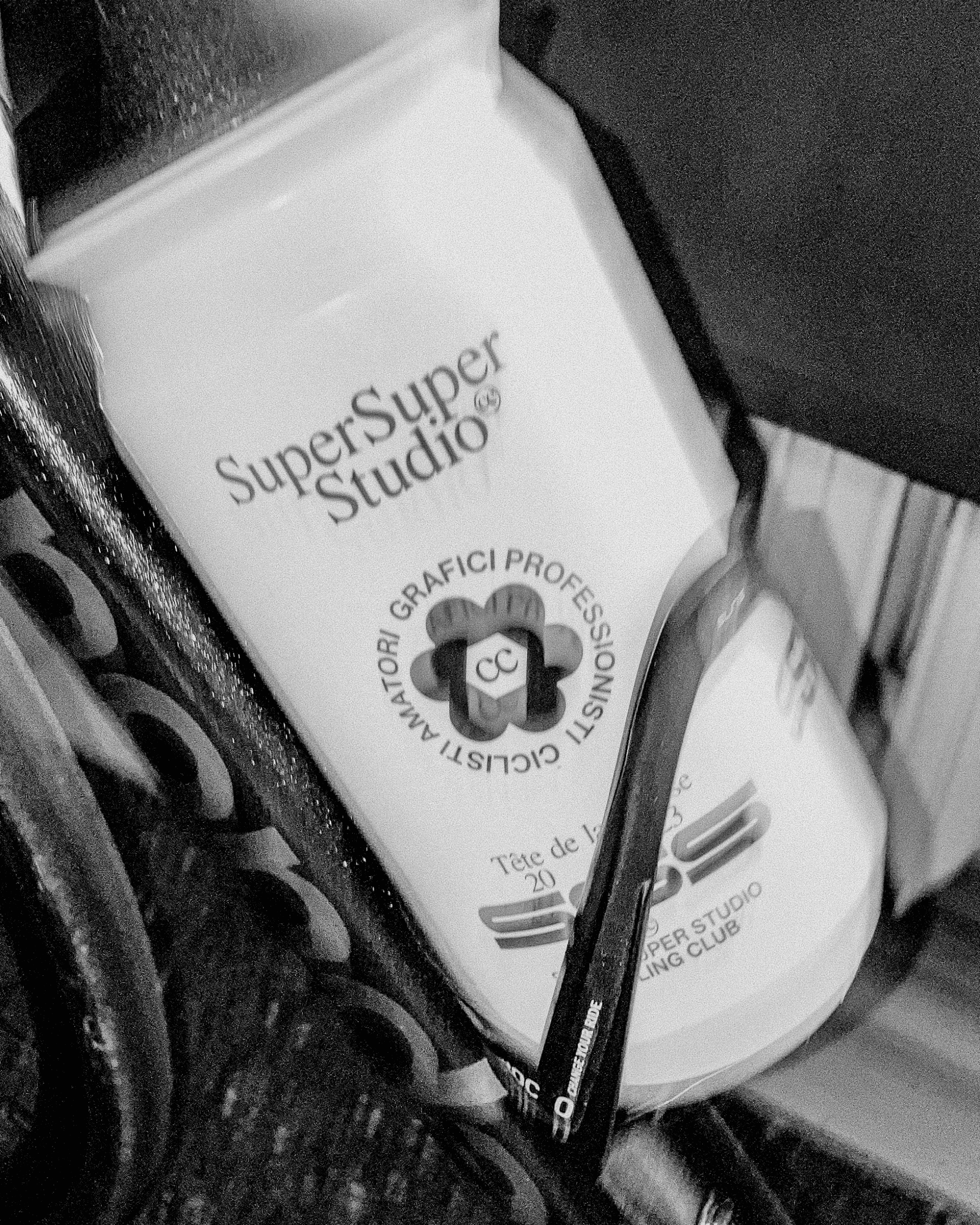 White and black bidon on bike bottle holder, featuring the Super Super Studio Cycling Club design